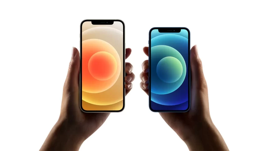 Two hands holding iPhone 12 mini models with colourful home screens.