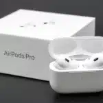 AirPods Pro earbuds with charging case and box.