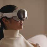 Woman wearing an Apple Vision headset indoors.