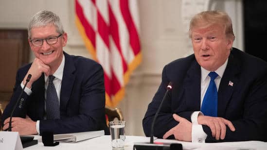 Tim Cook and Donald Trump speaking at a meeting.