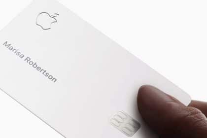 A hand holding an Apple Card with the name Marisa Robertson.