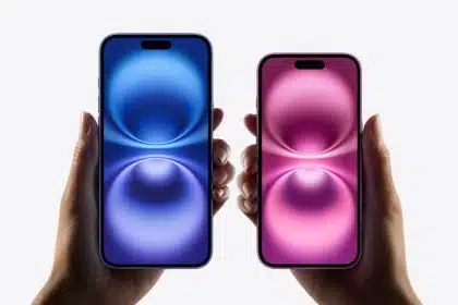 Two hands holding blue and pink iPhones.