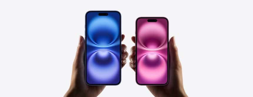 Two hands holding blue and pink Apple iPhones side by side.