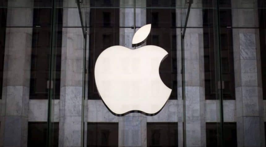 Apple logo displayed on a glass building facade.