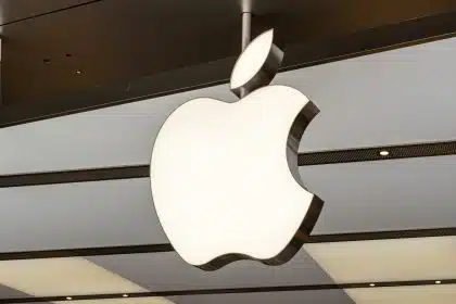 Illuminated Apple logo hanging inside an Apple Store.