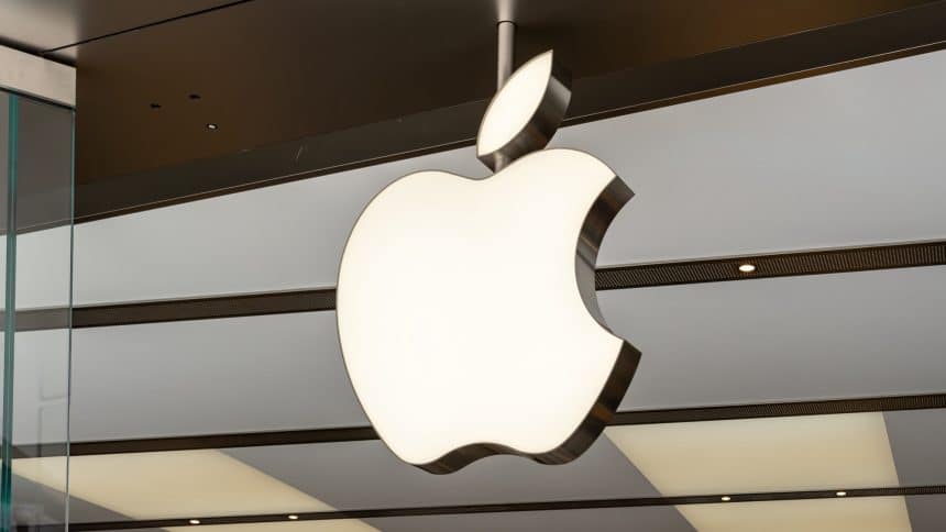 Illuminated Apple logo hanging inside an Apple Store.