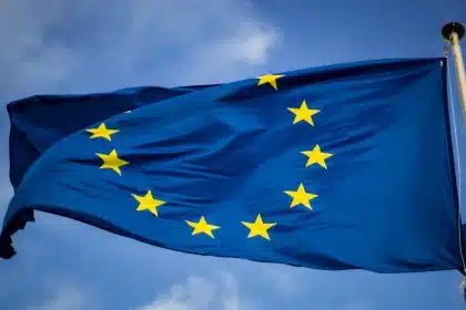 European Union flag waving against blue sky.