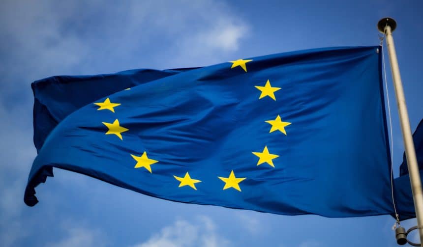 European Union flag waving against blue sky.