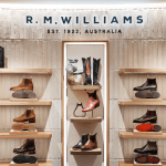 R.M. Williams store display with boots, bags, and accessories.