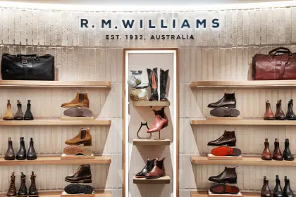 R.M. Williams store display with boots, bags, and accessories.
