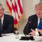 Tim Cook and Donald Trump speaking at a meeting.