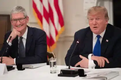 Tim Cook and Donald Trump speaking at a meeting.