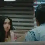 Scene from the film 'Last Scene' showing two characters talking in a diner.