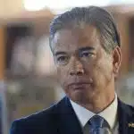 California Attorney General Rob Bonta looks serious during a press event.
