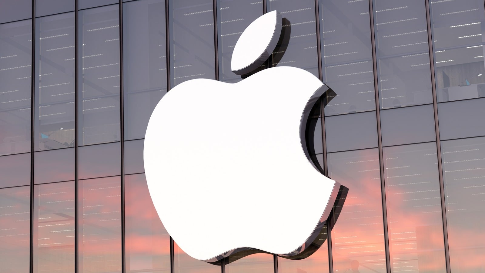 Large white Apple logo on the glass exterior of an Apple building.