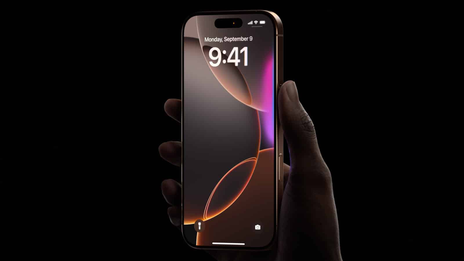 Hand holding a locked iPhone with a dark screen background.