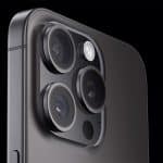 Close-up of the iPhone camera lenses on a dark background.
