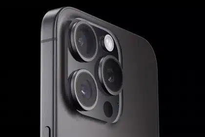 Close-up of the iPhone camera lenses on a dark background.