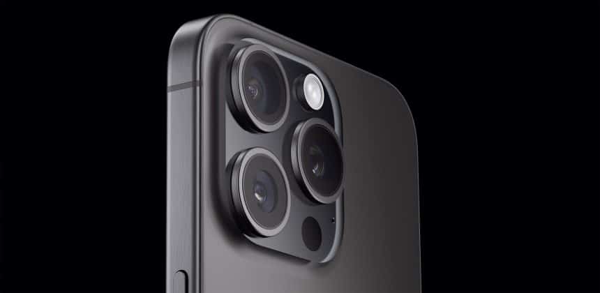 Close-up of the iPhone camera lenses on a dark background.
