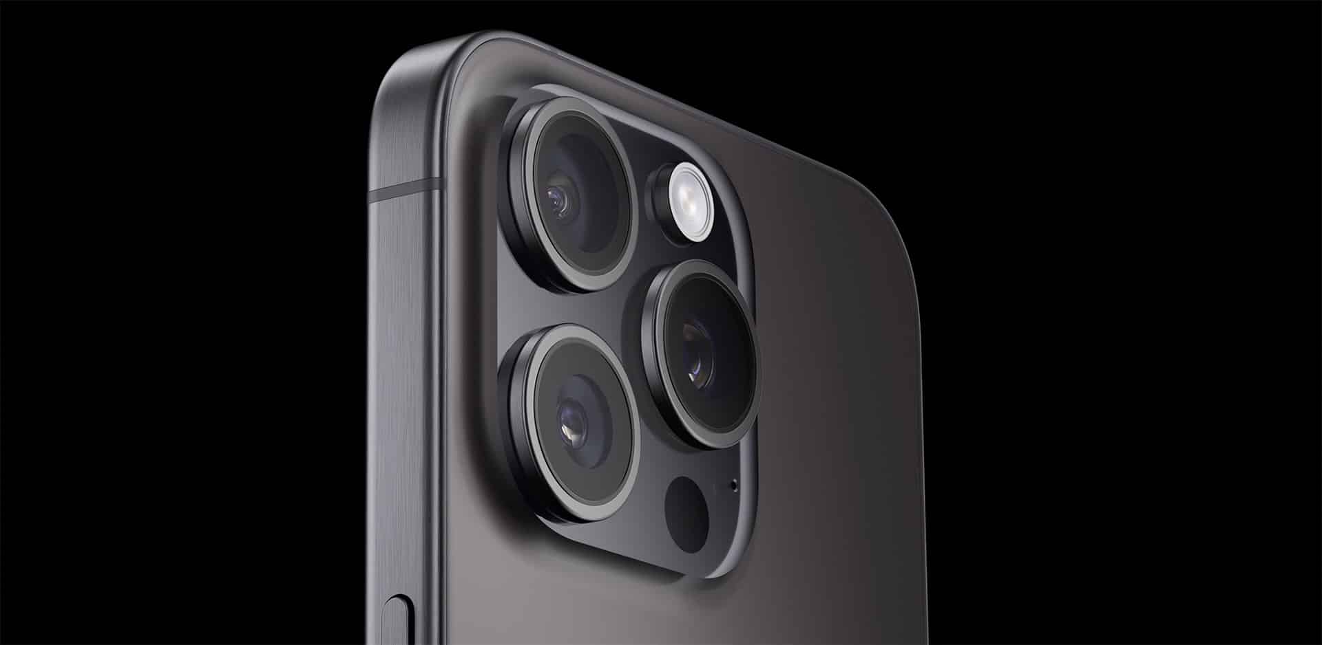 Close-up of the iPhone camera lenses on a dark background.