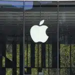 Apple logo displayed on a glass storefront.