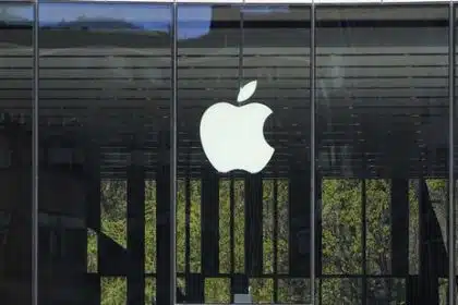 Apple logo displayed on a glass storefront.