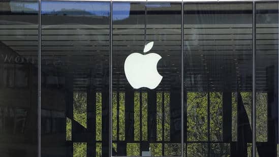 Apple logo displayed on a glass storefront.