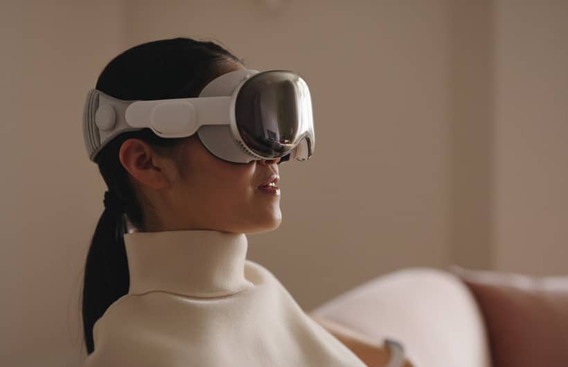 Woman wearing Apple Vision Pro headset.