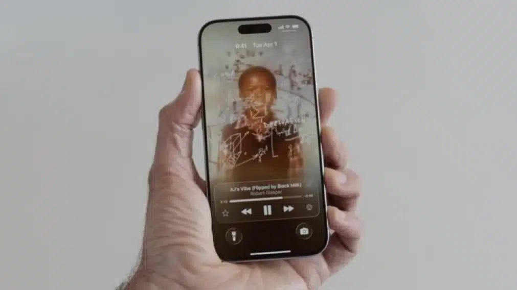 Hand holding an iPhone showing animated album art and music controls on the lock screen.