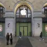 People stand outside the new Apple Store in Perth City, set in a historic building.