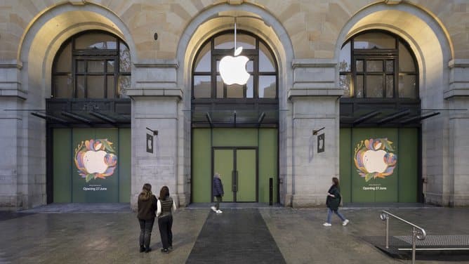 People stand outside the new Apple Store in Perth City, set in a historic building.