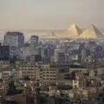 Cairo skyline with the Giza pyramids in the background.