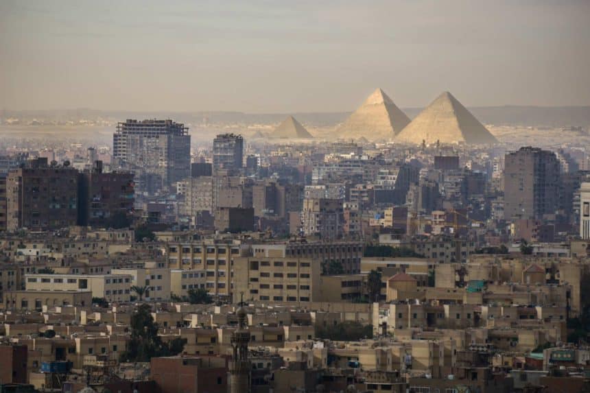 Cairo skyline with the Giza pyramids in the background.