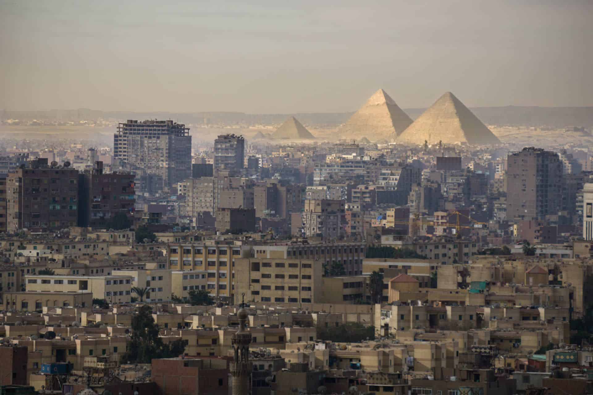 Cairo skyline with the Giza pyramids in the background.