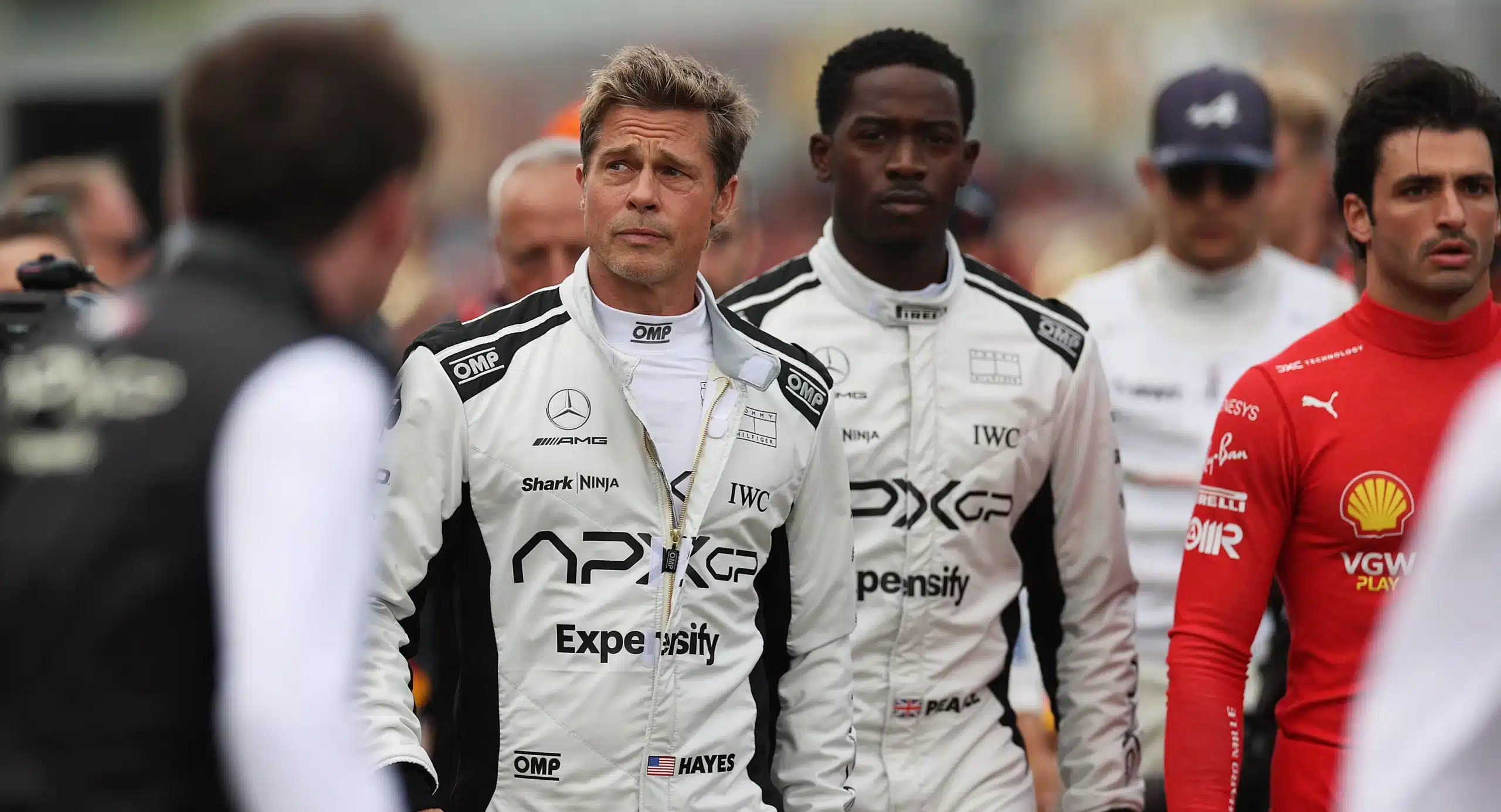 Brad Pitt and co-stars in racing suits on the set of the movie F1.