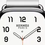Close-up of an Apple Watch Hermès with a white analog watch face.