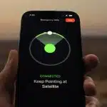 Hand holding an iPhone displaying the Emergency SOS satellite connection screen.