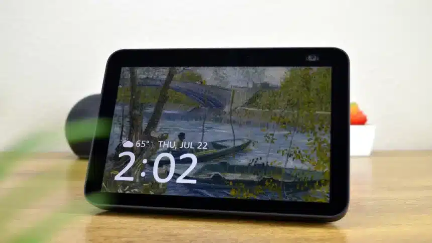 A tabletop smart display showing the time, date, and weather over a Van Gogh–style art wallpaper.