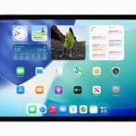 iPad home screen showing clock, weather, photo, and calendar widgets above app icons on a blue-green background.