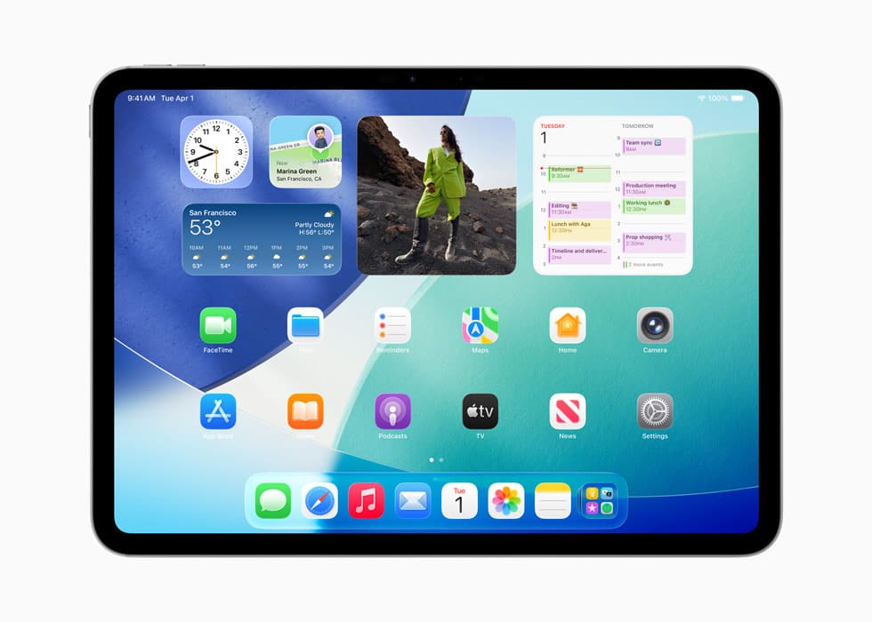 iPad home screen showing clock, weather, photo, and calendar widgets above app icons on a blue-green background.