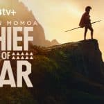 Jason Momoa stands on a cliff holding a spear in the promotional poster for Chief of War on Apple TV+.