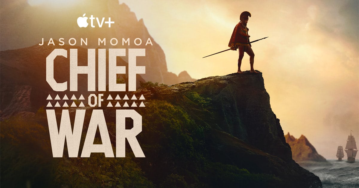 Jason Momoa stands on a cliff holding a spear in the promotional poster for Chief of War on Apple TV+.