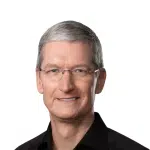 Portrait of Tim Cook wearing glasses and a black shirt on a white background.