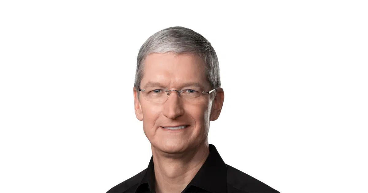 Portrait of Tim Cook wearing glasses and a black shirt on a white background.