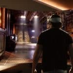 Person wearing Apple Vision Pro headset exploring a sci-fi virtual environment.