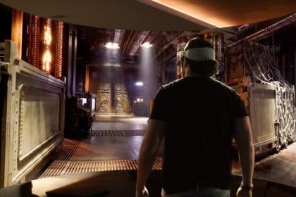 Person wearing Apple Vision Pro headset exploring a sci-fi virtual environment.