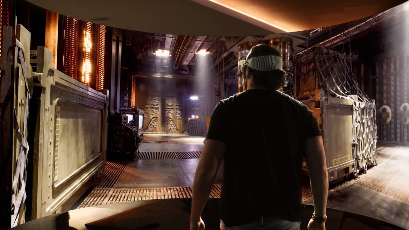 Person wearing Apple Vision Pro headset exploring a sci-fi virtual environment.