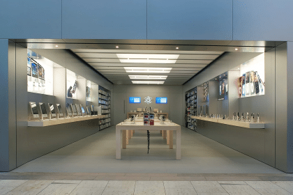 Apple Store with product displays and tables inside a shopping mall.