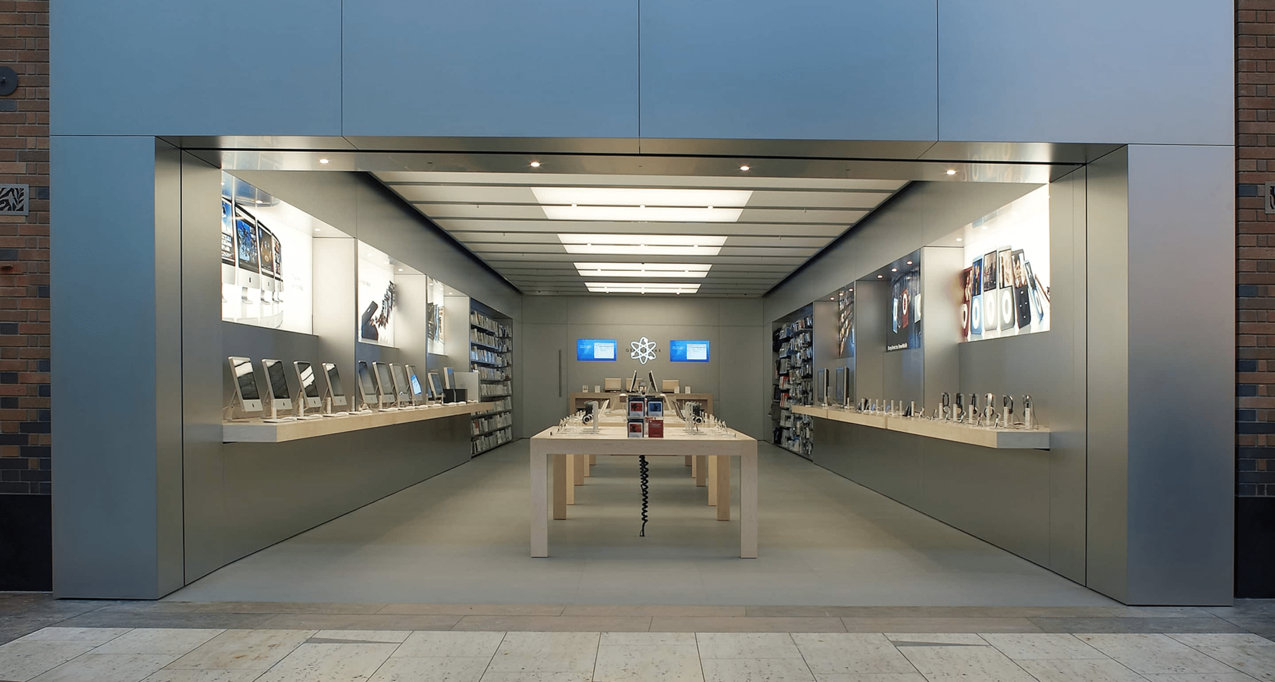 Apple Store with product displays and tables inside a shopping mall.