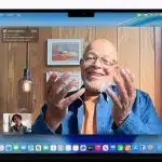 Person using FaceTime on a MacBook running macOS Tahoe.